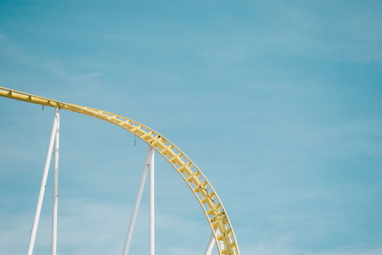 yellow curve Amusement Park Rides Amusementpark Arts Culture And Entertainment Blue Curve Day Fairground Ride Fun High Section High Up Low Angle View No People Outdoors Sky Tourism Traveling Carnival The Color Of Technology Paint The Town Yellow