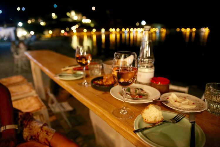 Close-up of fresh food and drink on table at night