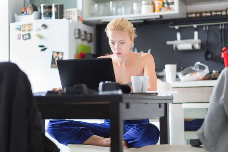 Business woman using laptop while sitting at home