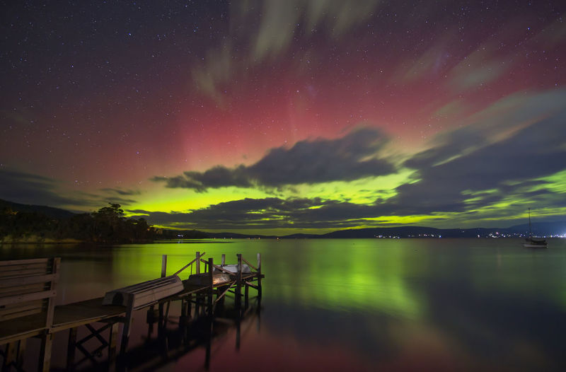 Scenic view of lake against sky at night