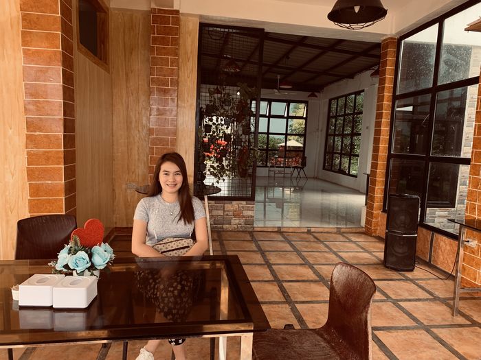 Young woman sitting on chair from an old house.