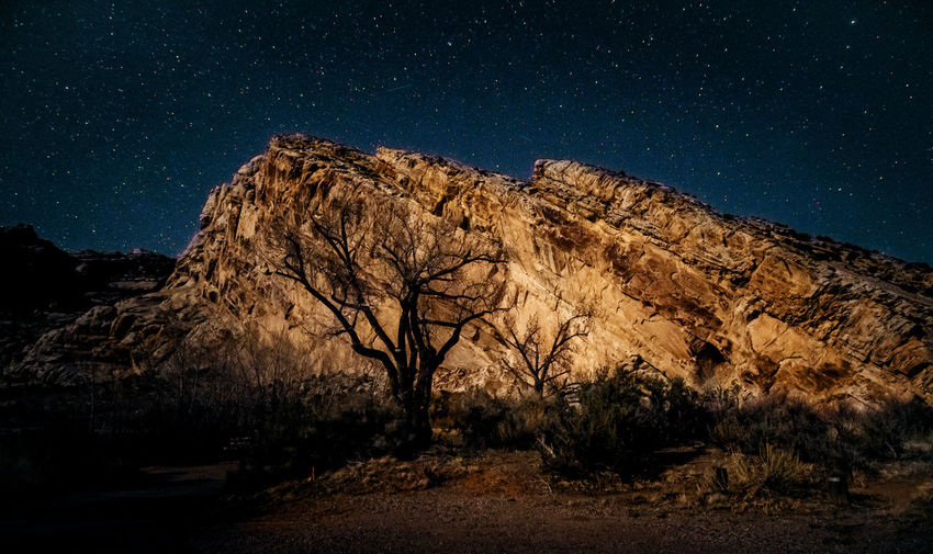 Scenic view of land against sky at night