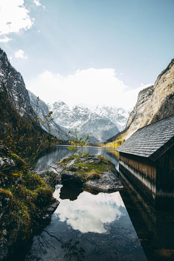 Scenic view of river amidst mountains against sky