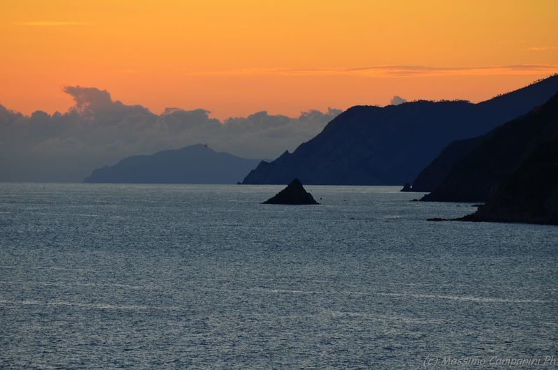 River by silhouette mountains during sunset