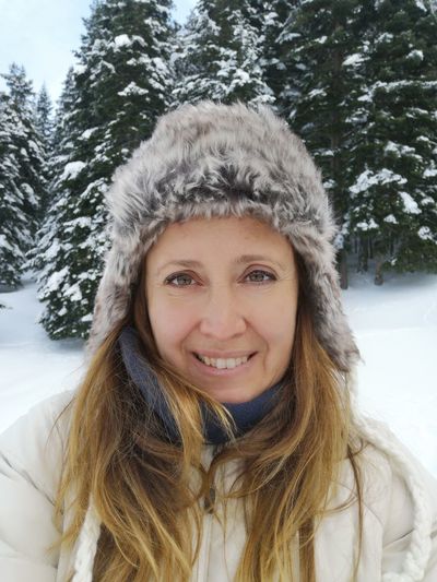 Portrait of smiling woman in snow