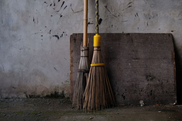Close up of a broom sticks in front of the house.
