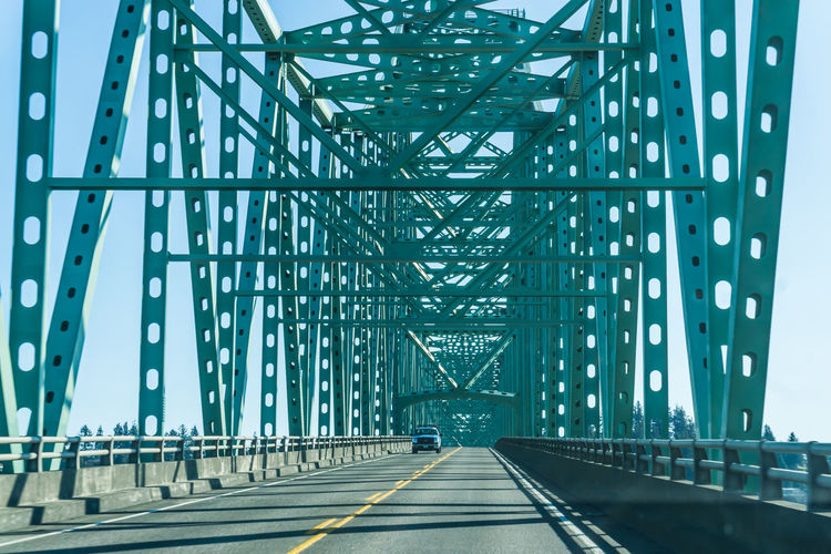 View of car on bridge against blue sky
