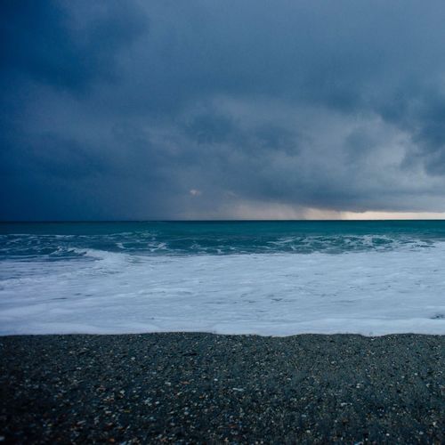 Scenic view of sea against cloudy sky
