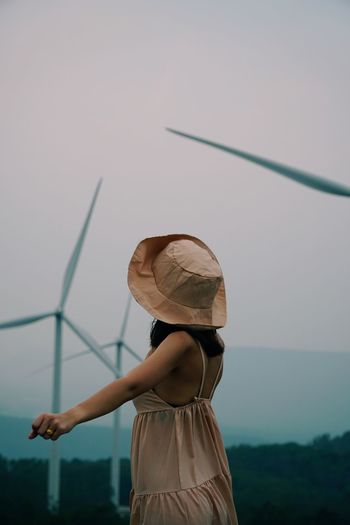 Rear view of woman standing against sky