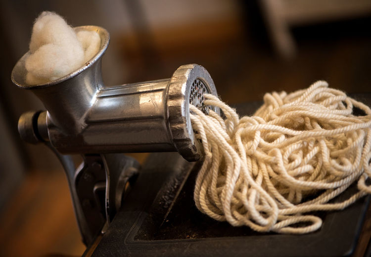 Close-up of machinery with ropes on table