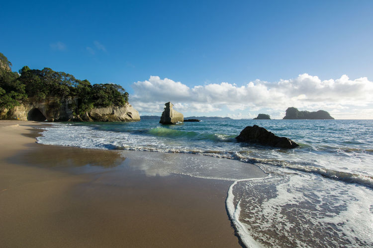 Scenic view of sea against blue sky at cathedral cove