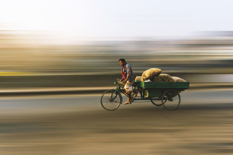 Vendor riding pedicab on road