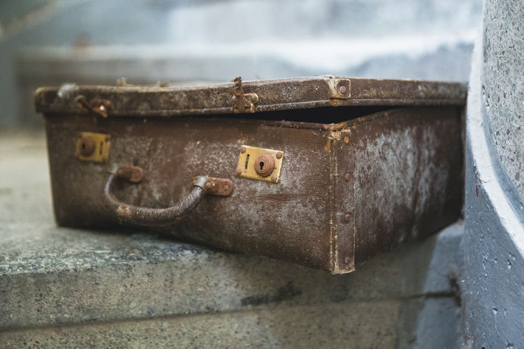 Close-up of old rusty metal suitcase