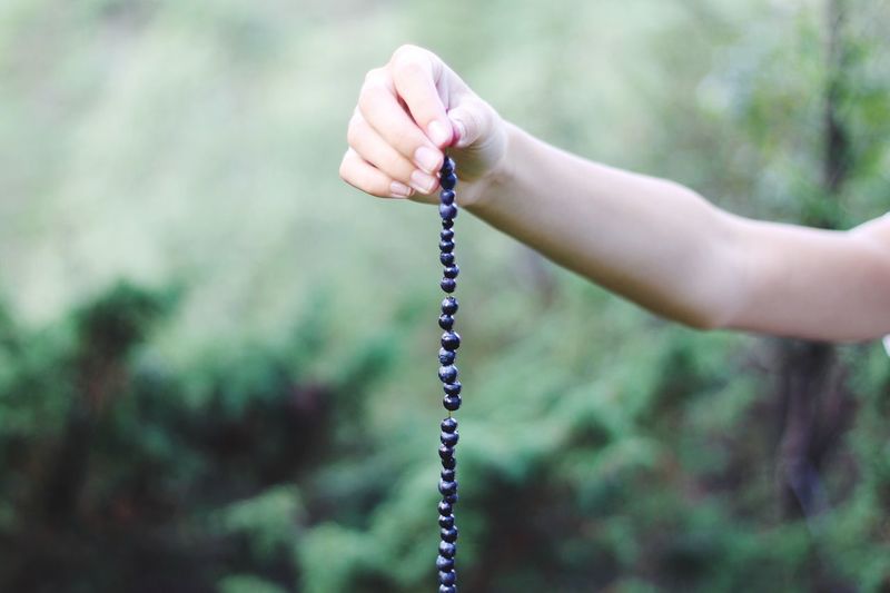 Cropped hand holding bead