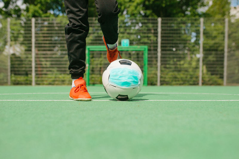 Low section of man playing soccer ball