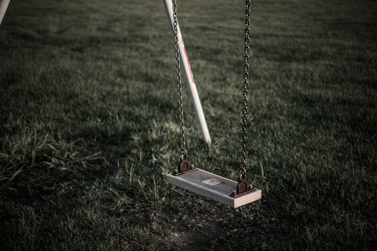 Swing over grassy field in park