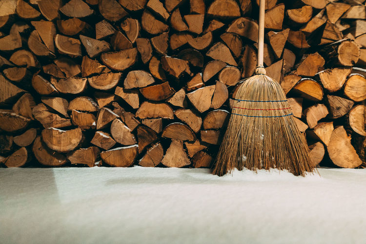 Broom and firewood by snow
