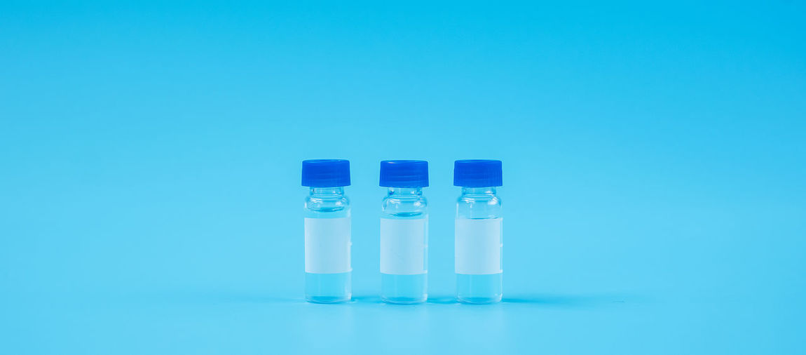 Close-up of vials against blue background
