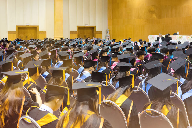 Students sitting in auditorium during graduation ceremony