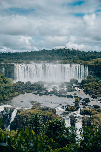 Scenic view of waterfall against sky