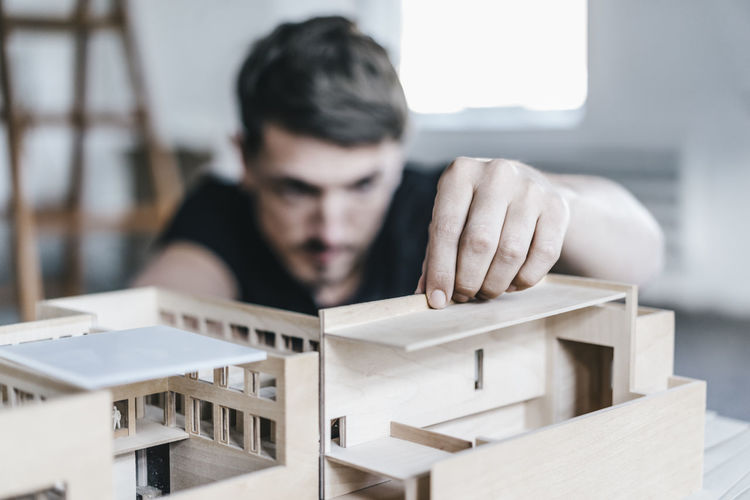 Architect working on architectural model