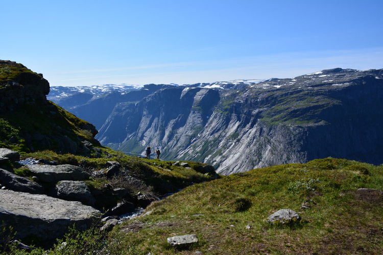 Scenic view of mountains against blue sky