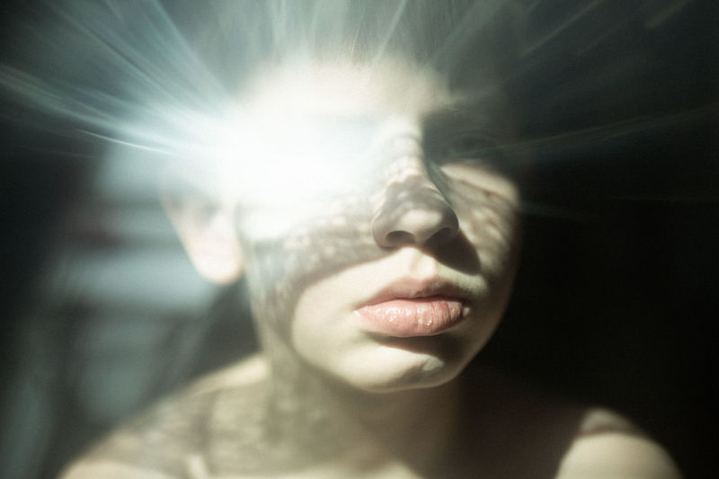 Close-up of boy with glowing eye