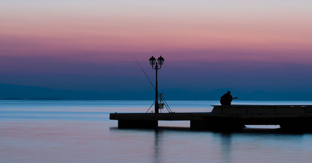Silhouette pier on sea against sky during sunset