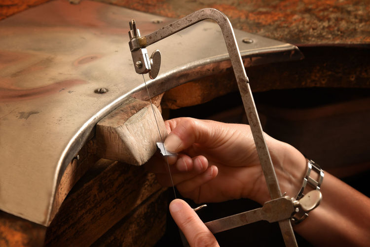 Cropped hand of manual worker working in factory