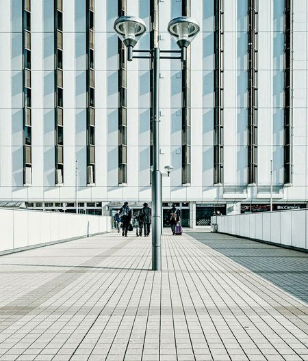 Reflection of people on glass building