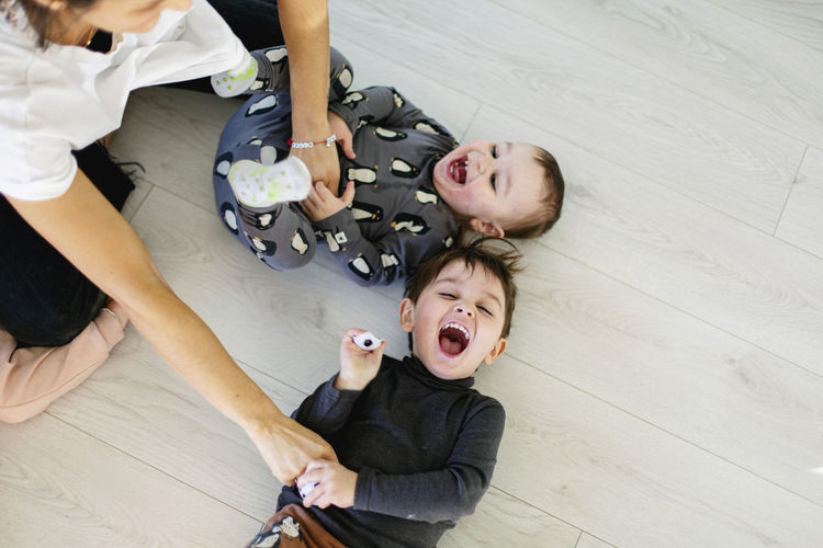 High angle view of boy and son on floor