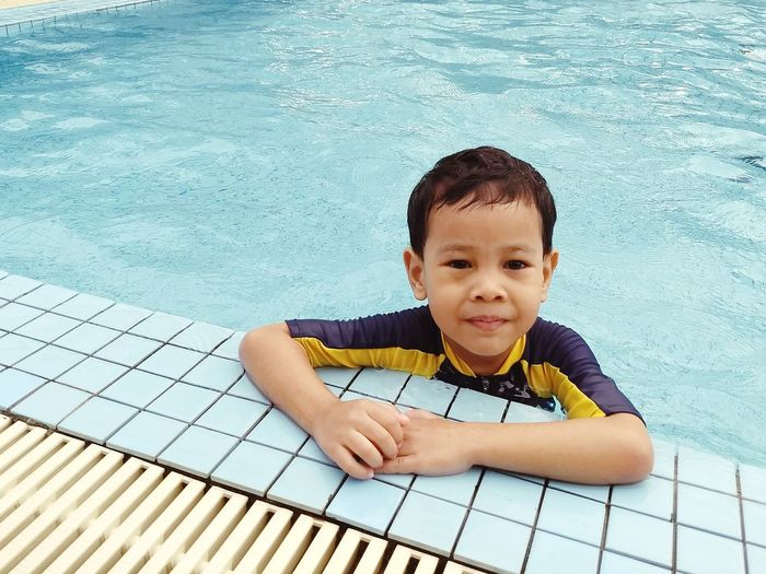 Portrait of happy boy in swimming pool