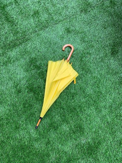 High angle view of yellow umbrella on field