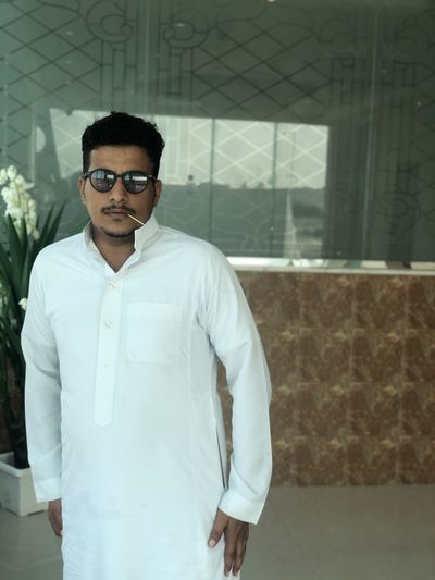Portrait of young man standing in hallway