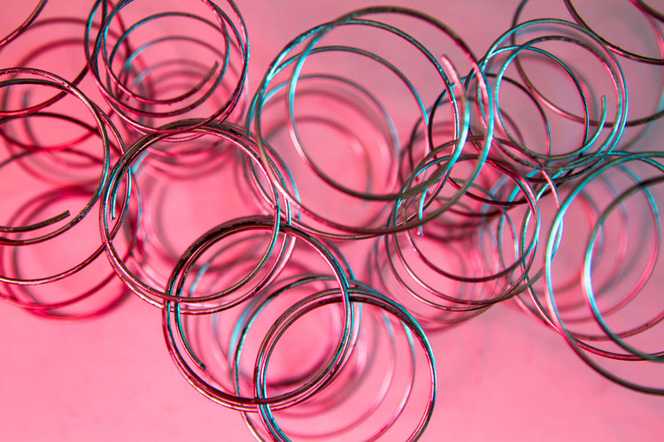 Production of independent springs for mattresses. independent spring blocks on pink background. 