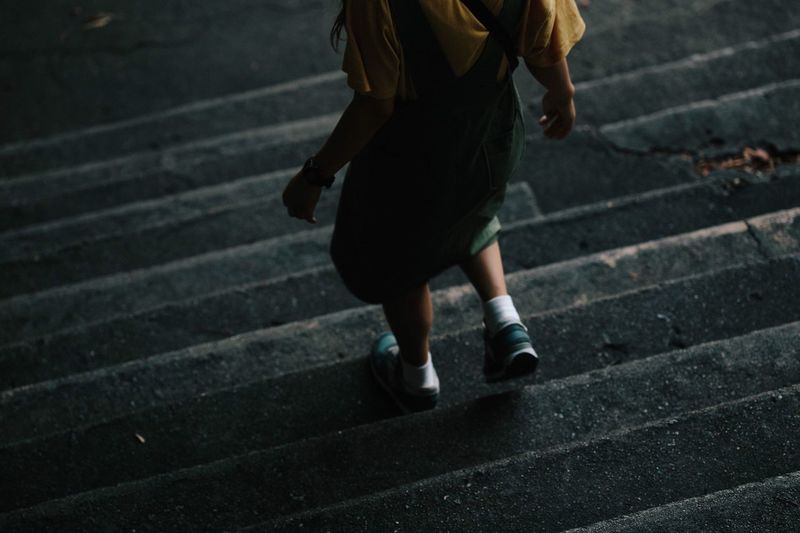 Low section of girl walking on steps