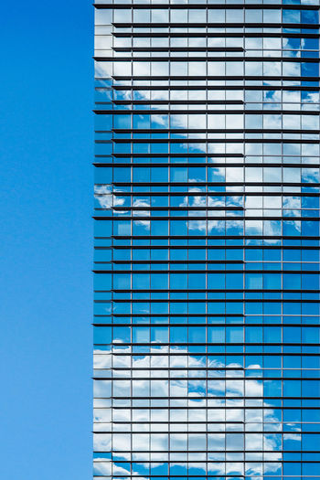 Full frame shot of modern building against blue sky