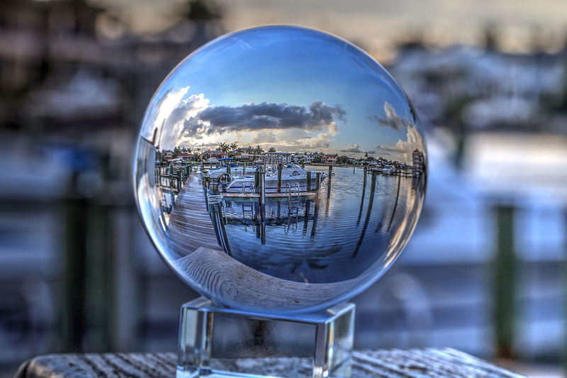 Crystal ball of boats docked at a marina near venetian bay in naples, florida at sunrise.