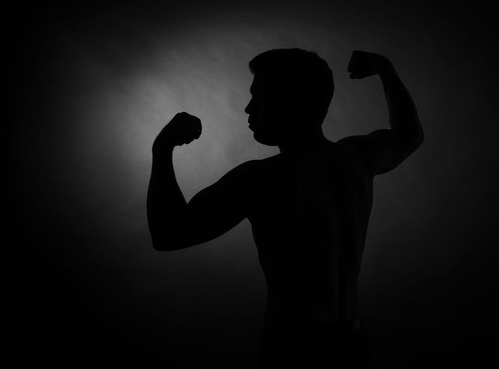 Silhouette woman standing against gray background