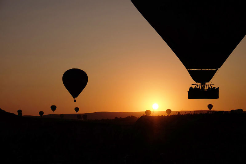 Silhouette of hot air balloon against sky during sunset, cappadocia