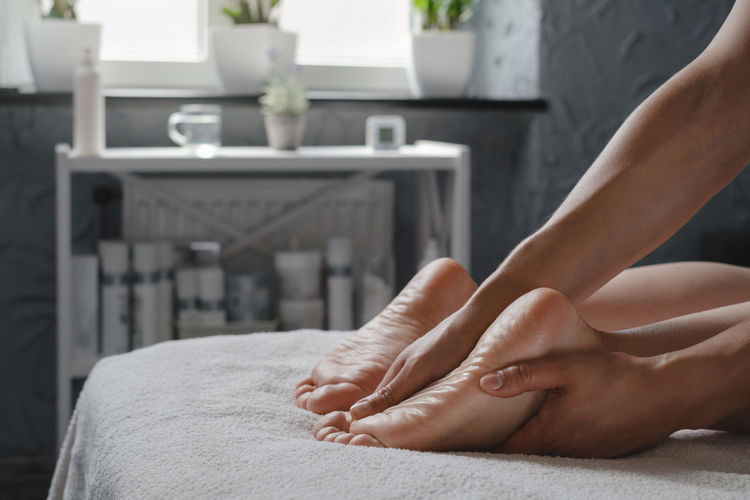 Woman foot spa massage treatment by professional massage therapist in spa resort. wellness