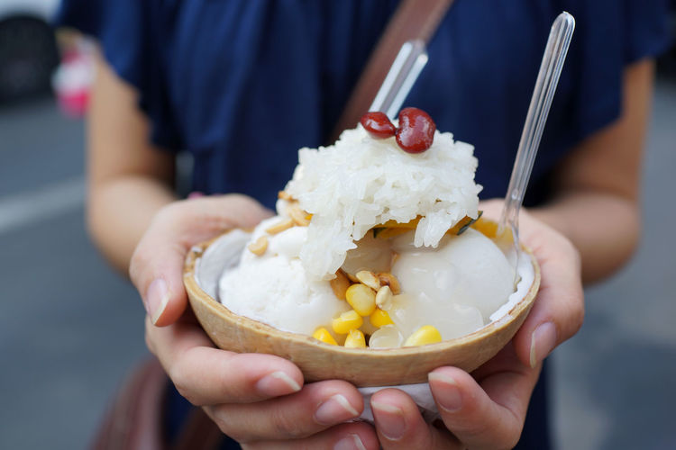 Close-up of hand holding ice cream