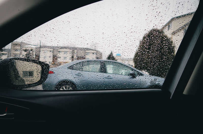 Wet car window in rainy season