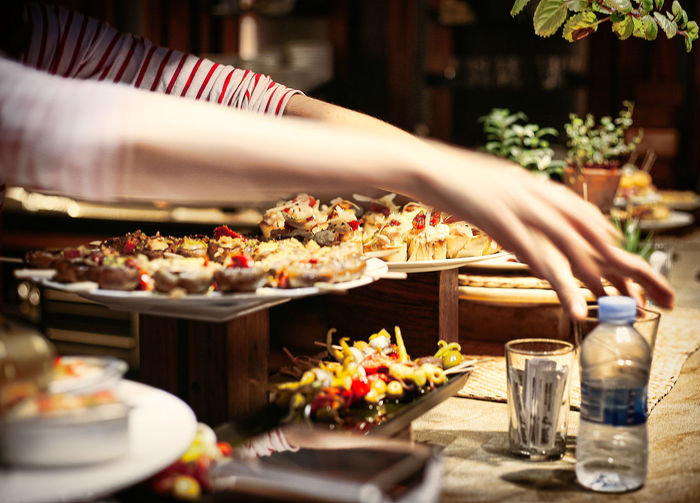Close-up of hand with drink served on table