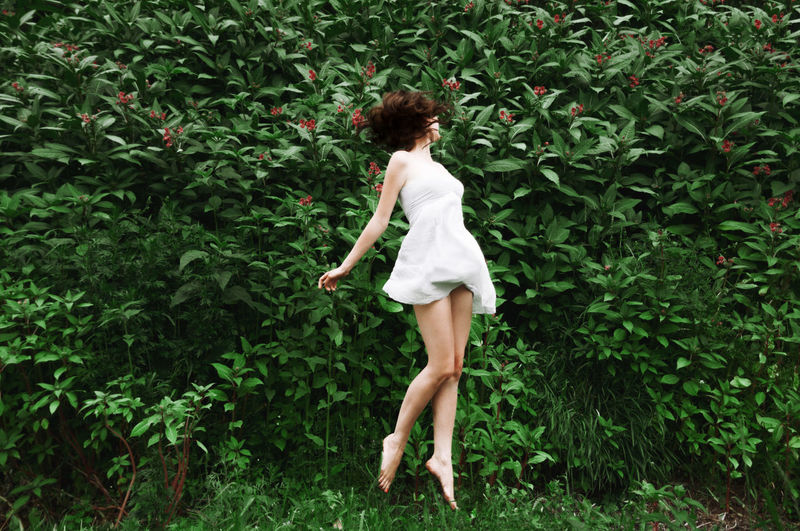 Woman jumping in grass