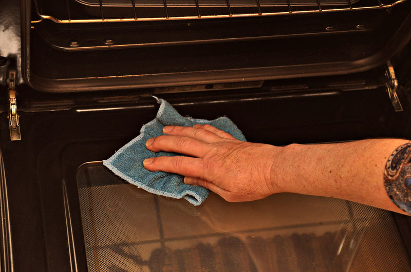Close-up of man holding hands at home