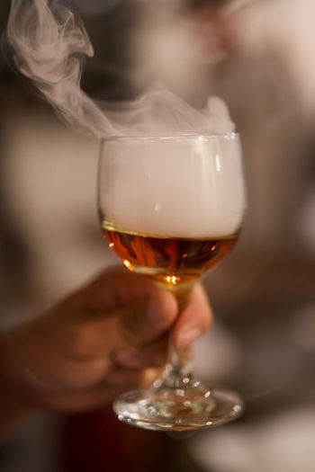 Close-up of hand holding wineglass