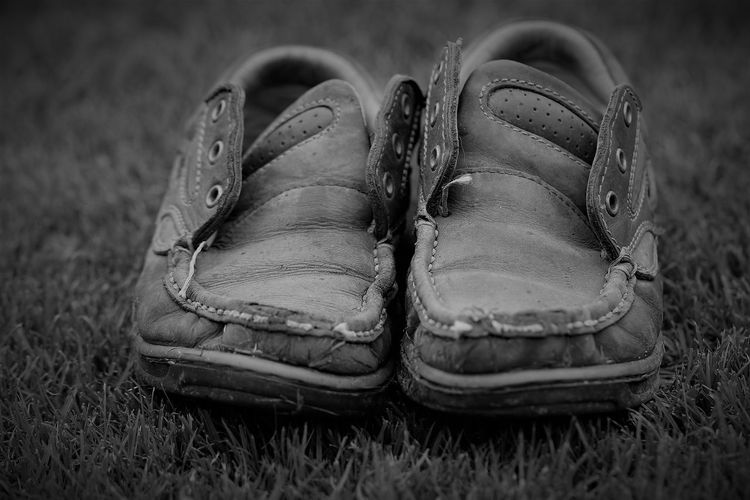 Close-up of old shoes on field