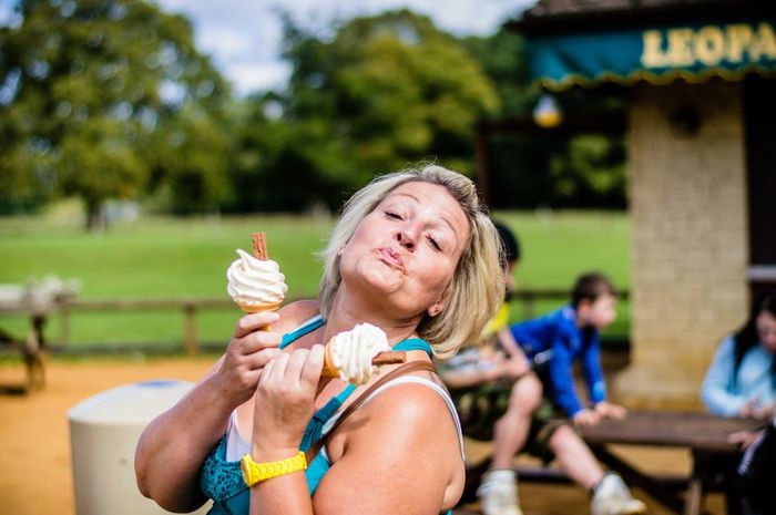 Woman with ice cream in park