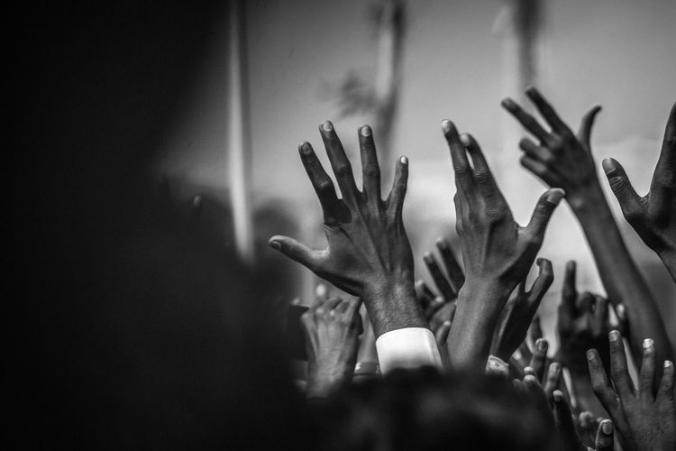 Close-up of raised hands